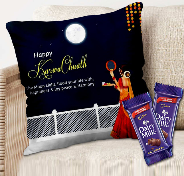 Decorative pillow with 'Happy Karwa Chauth' text and two Cadbury Dairy Milk chocolate bars on a couch.