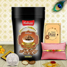 Rakhi presentation with gourmet almonds, elegant silver coin, symbolic roli-chawal, and festive greeting card for the occasion.