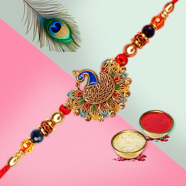 Beautiful Rakhi embellished with a peacock motif and shimmering stones for an elegant festive look.