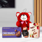 Red teddy bear, Cadbury Chocobakes cookies, watch, and card 