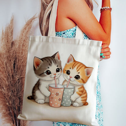 Tote bag with two cartoon kittens drinking from colorful cups held by a person.
simple tote bag for daily use
tote bag with waterproof lining
