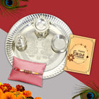 silver plated thali with traditional rakhi and a greeting card 